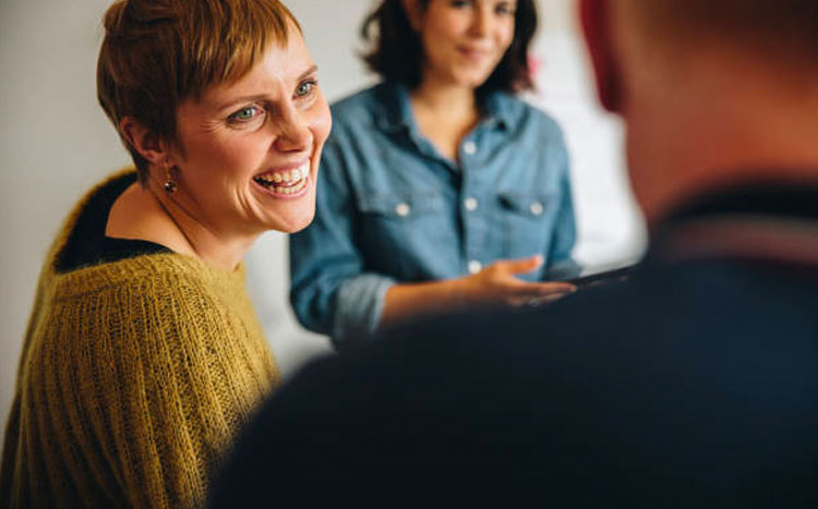 Man and woman having a conversation - woman is smiling